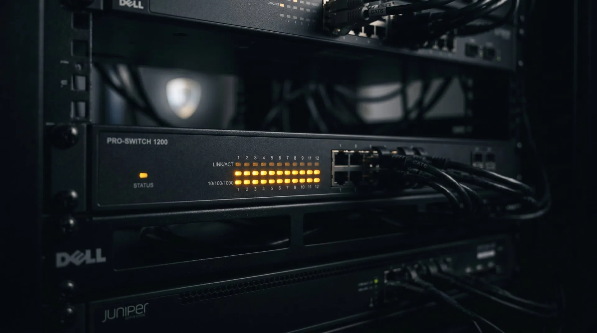 An abstract shield-like light pattern over a dark server backdrop, representing always-on website security
